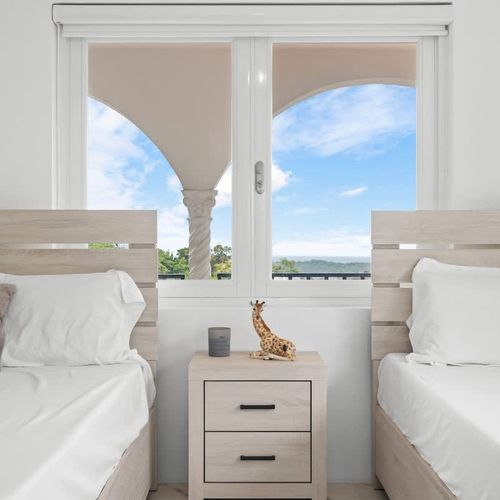 A spacious bedroom with large windows offering natural light.