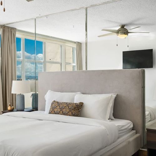 A peaceful retreat awaits. Enjoy ample natural light and refreshing breezes in this thoughtfully designed bedroom, complete with a modern ceiling fan for your comfort.