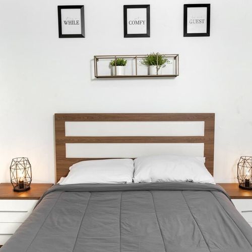 Indulge in peaceful slumber in this elegantly appointed bedroom. A comfortable queen-sized bed, stylish bedside tables with soft lighting, and captivating wall art create a serene and inviting atmosphere. Your perfect night's rest awaits.