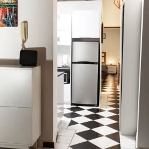 Cook and dine with ease in the modern and well-equipped kitchen. The clean and stylish checkered floor tiles, ample counter space, and stainless steel appliances make meal preparation a delight during your stay.