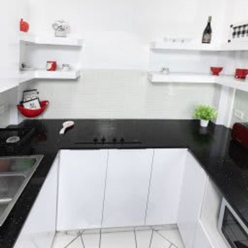 Cook and dine with ease in the modern and well-equipped kitchen. The clean and stylish checkered floor tiles, ample counter space, and stainless steel appliances make meal preparation a delight during your stay.