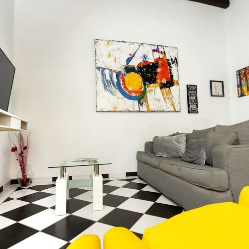 Unwind in the heart of comfort! This spacious living room, adorned with a cozy grey sofa and elegant wall art, is your personal sanctuary after a day of discovery. Perfect for quiet evenings or engaging conversations.