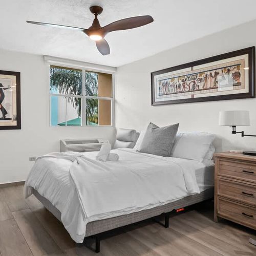 Bright and spacious bedroom with comfortable bed and natural light. A peaceful and inviting atmosphere awaits.