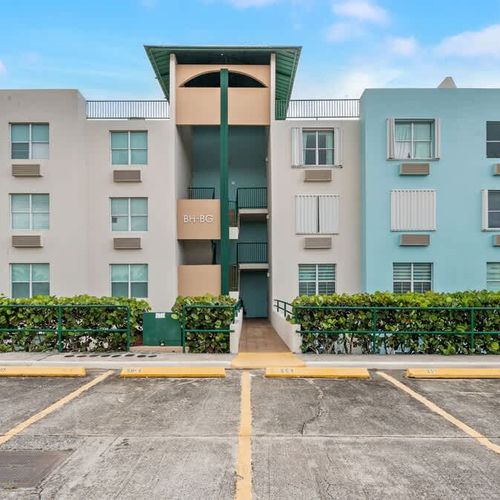 Charming exterior with lush landscaping, offering a welcoming first impression. Your inviting home away from home.