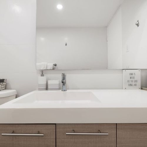 Bright lighting and a modern mirror setup make this bathroom ideal for getting ready.