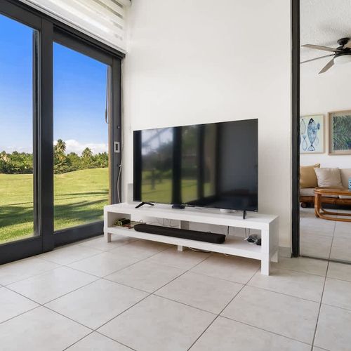 Enjoy your favorite shows on the large screen in this modern living room.