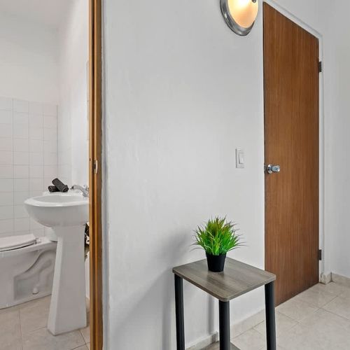 Indulge in comfort with a brightly lit bathroom furnished with modern decor.