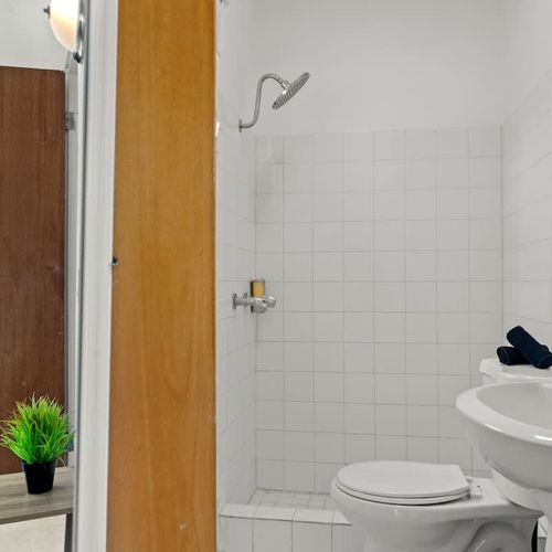 Our bright bathroom is fitted with a large window for natural light.