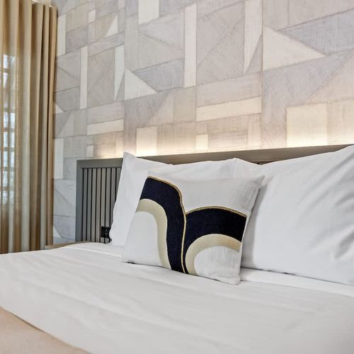 Relax in this airy and bright expired where every element from the soft headboard lighting to the pristine flooring exudes sophistication and comfort.