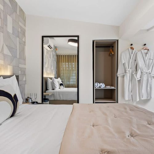 This calming bedroom features a plush queen-size bed with crisp white linens, inviting you to unwind after a day of exploring.