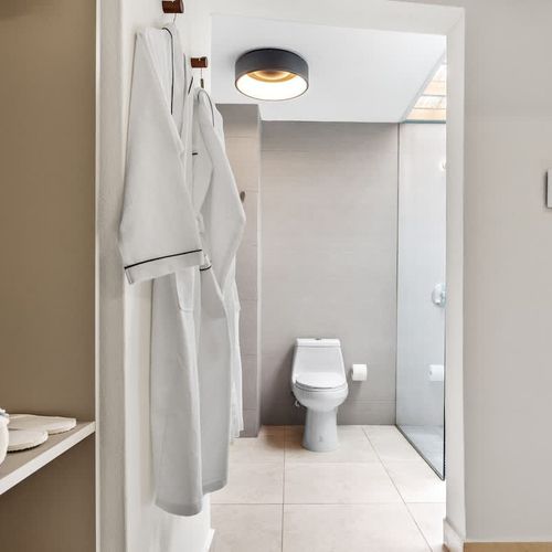 Inviting chamber that opens up to an organized closet area, ensuring all your belongings are neatly stored away during your visit.