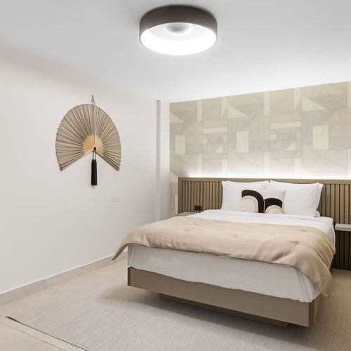 Modern headboard with warm wood accents adds a touch of elegance.