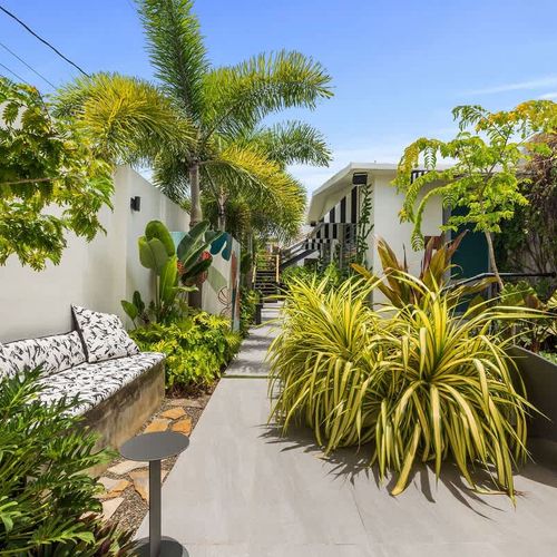 Unwind and recharge in our enchanting outdoor space. Take a dip in the pool, surrounded by lush greenery and playful signage, or challenge yourself in our well-equipped alfresco gym.