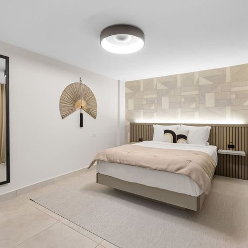 Invitingly plush bed with crisp white linens for a restful sleep.