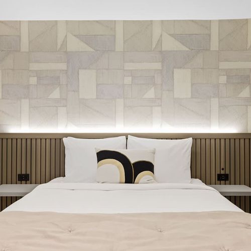 Ample space on either side of the bed for bedside tables and personal belongings.