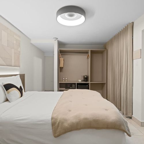 A cozy bedroom with soft, muted tones and a plush comforter inviting you to sink into a restful sleep.