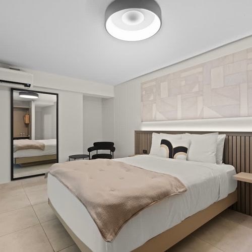 A vintage-inspired bedroom with large mirror.