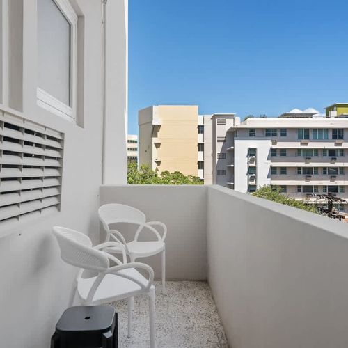 Enjoy the lively cityscape from your private balcony! It's the perfect spot to sip your morning coffee or unwind with an evening drink while taking in the views.