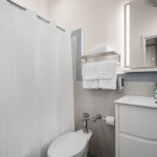 Our spotless bathroom is fully equipped with fresh, fluffy towels and all the essentials, ensuring a clean and comfortable experience for every guest.