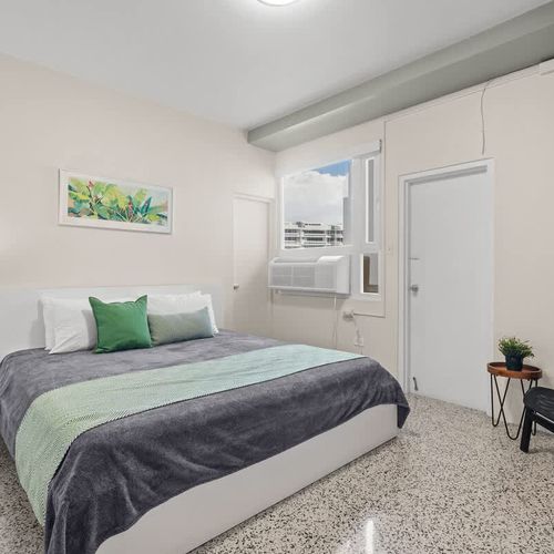 Step into a clean and comfortable space designed for your relaxation. This bright bedroom offers a tranquil setting for a perfect night's sleep.