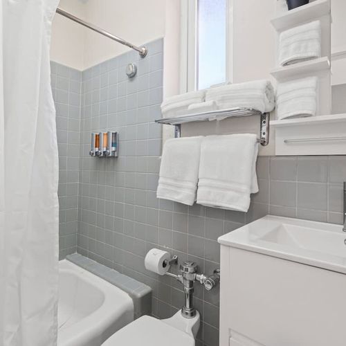 Our spotless bathroom provides all the essentials for your comfort, including fresh, soft towels, and a sparkling clean shower area to refresh and rejuvenate.