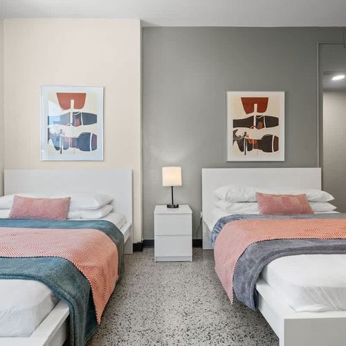 Ideal for friends or family, this room offers two comfortable twin beds, each beautifully made with fresh linens, ensuring a restful night's sleep for everyone.