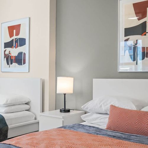 Ideal for friends or family, this room offers two comfortable twin beds, each beautifully made with fresh linens, ensuring a restful night's sleep for everyone.