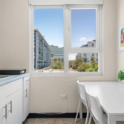 Enjoy the convenience of a dedicated desk area with a mini-fridge and a toaster, perfect for preparing light meals, snacks, or keeping your beverages chilled during your stay.