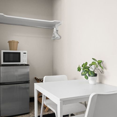 Beyond just a bed! This versatile space offers a comfortable sleeping area plus a cozy nook with a table and chairs, perfect for morning coffee or a quick bite.