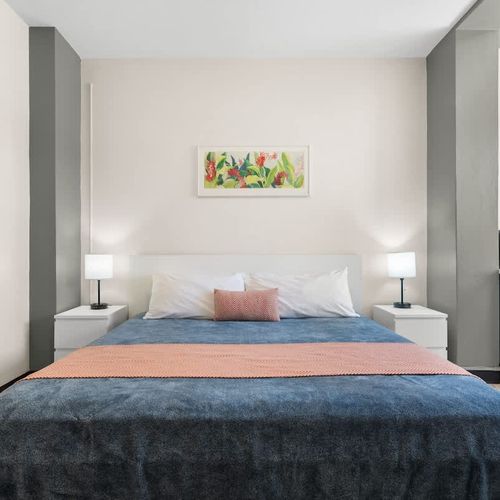 Step into comfort and relaxation! This bright and inviting bedroom offers a plush bed and ample space to unwind after a day of exploring.