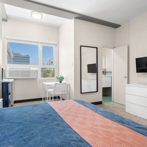 Experience peaceful sleep in our meticulously prepared bedroom, featuring a comfortable bed with fresh linens and soft lighting for a truly restful stay.