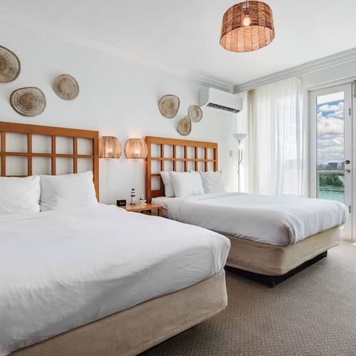 Enjoy the comfort and flexibility of two beds in this charming bedroom for a perfect night's sleep.