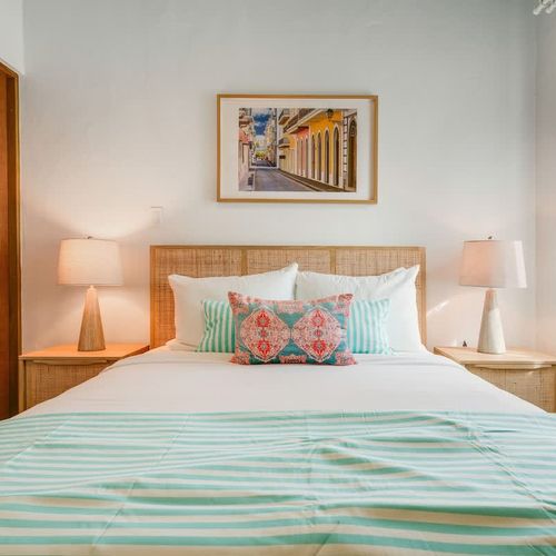 A modern bedroom with artistic touches and a comfy bed for a cozy stay.