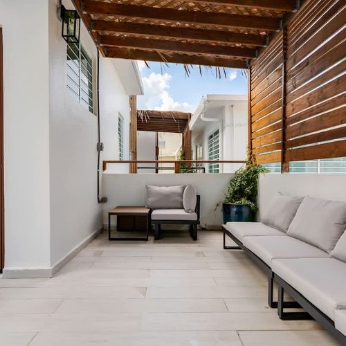 Unwind in this chic outdoor seating area, perfect for a fresh breeze.
