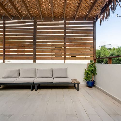 Find calmness and peace on this comfortable, covered deck for your morning coffee.