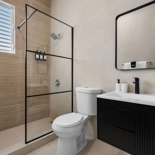 Spacious bathroom with a modern shower and minimalist design.