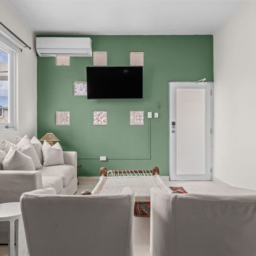 Relax on a comfortable sofa in a sun-filled room.