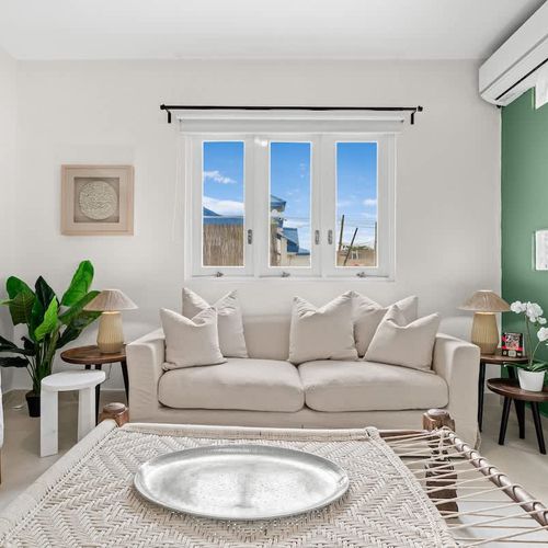 Bright living room with tropical touches and a cozy feel.