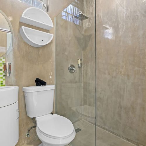 A clean, modern bathroom with a spacious glass-enclosed shower.