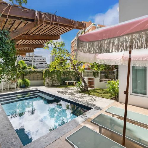 Relax under the parasol with a drink, and enjoy the sun.