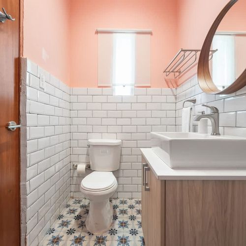 A tidy and sleek bathroom with a large mirror, great for getting ready.