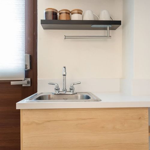 A compact kitchen area with a sink and plenty of counter space.
