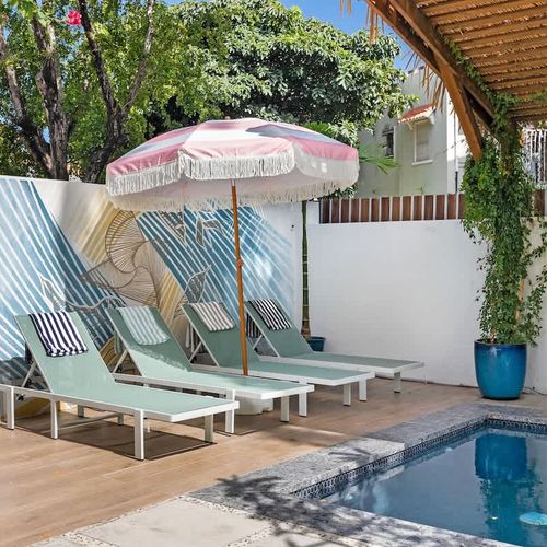 Your own outdoor space with a pool, hammock, and sunbeds.