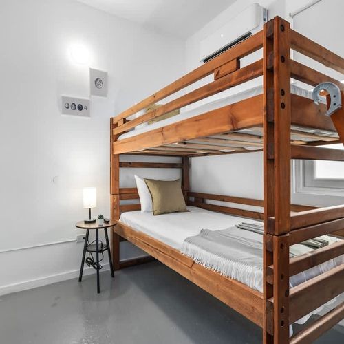 Chic minimalist room with stylish wooden bunks.