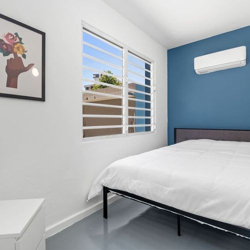 Wake up to serene urban views and a touch of greenery from the expansive window, promising a refreshing stay in the heart of the city.