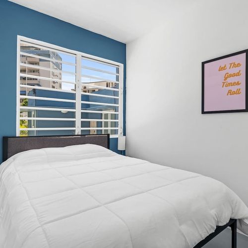 Wake up to the city view in this bright and modern bedroom.