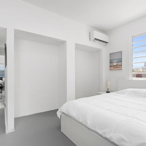 Experience peaceful nights in a generously sized bed, draped in soft, luxurious linens, providing the perfect blend of comfort and sophistication.