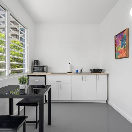 Enter the light-filled kitchenette, fully equipped with modern amenities, creating an ideal space for your stay.