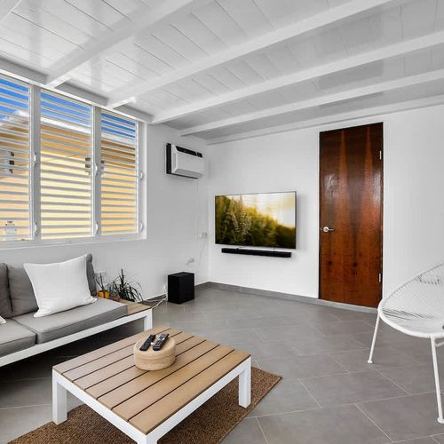 Kick back in the sun-filled lounge, featuring a soft sofa and large window – a perfect space to unwind, read a book, or binge your favorite series in comfort.