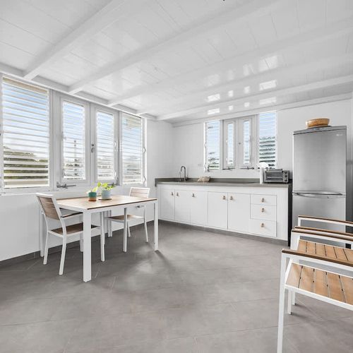 Gather around the chic dining table with easy flow into the open kitchen – fully equipped for guests who enjoy preparing meals or sharing cozy dinners at home.